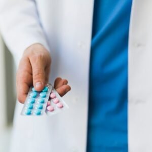Doctor holding pills